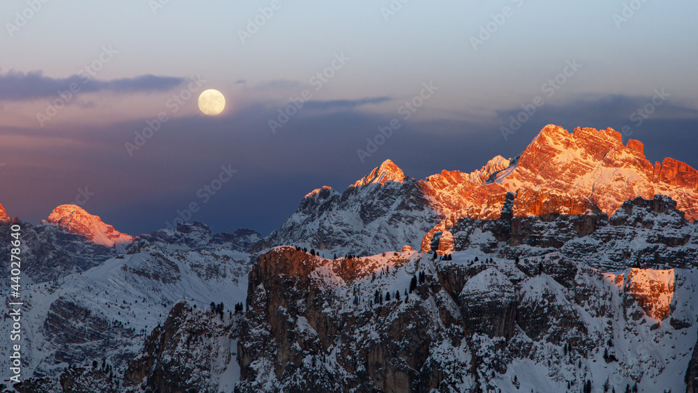 Full moon at sunset in the Dolomities