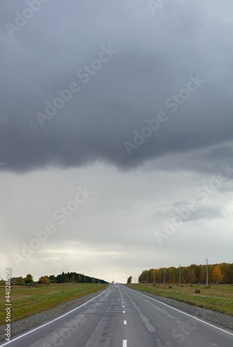 country road before the storm. panorama of the old intercity highway in bad weather in summer. road weather forecast concept. copy space