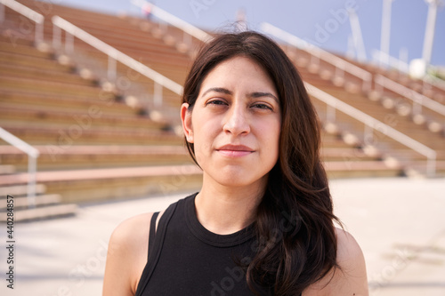 Obraz na płótnie Outdoor portrait of a Latina woman looking at the camera with a serious face