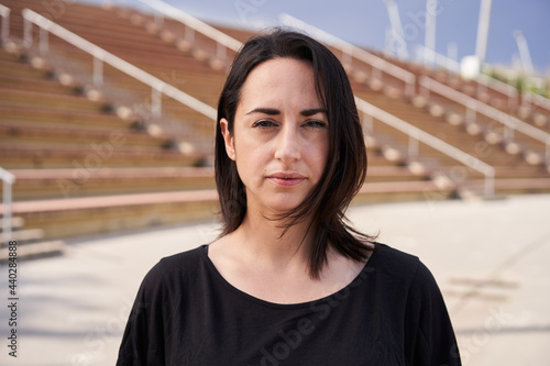 Photography Outdoor portrait of a Hispanic woman looking at the camera with a serious face
