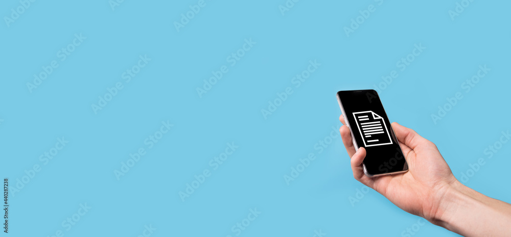 Male hand holding a document icon on blue background. Document Management Data System Business Internet Technology Concept. Corporate data management system DMS Male hand holding a document icon on blue background. Document Management Data System Business Internet Technology Concept. Corporate data management system DMS