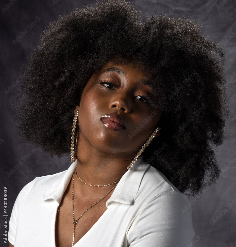 Beautiful young black woman with big hair and hoop earrings Stock Photo ...