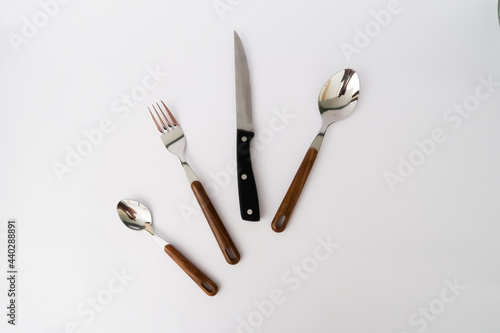 set cutlery of spoon  fork  and knife with a wood vintage handle on the white background.