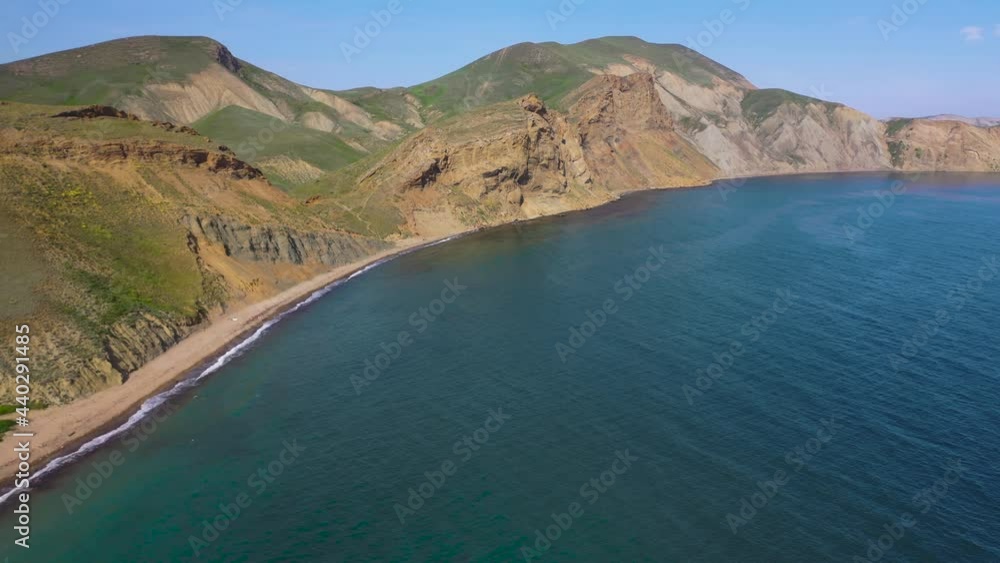 Tikhaya Cove of the Bay of Koktebel, Crimea. Aerial video of cliffed coast line cape Crimea Rocks line the shore of Black sea. Koktebel' area, Crimea. 