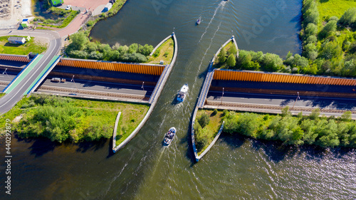 Aquaduct Veluwemeer, Nederland. Aerial view from the drone. A sailboat sails through the aqueduct on the lake above the highway. photo