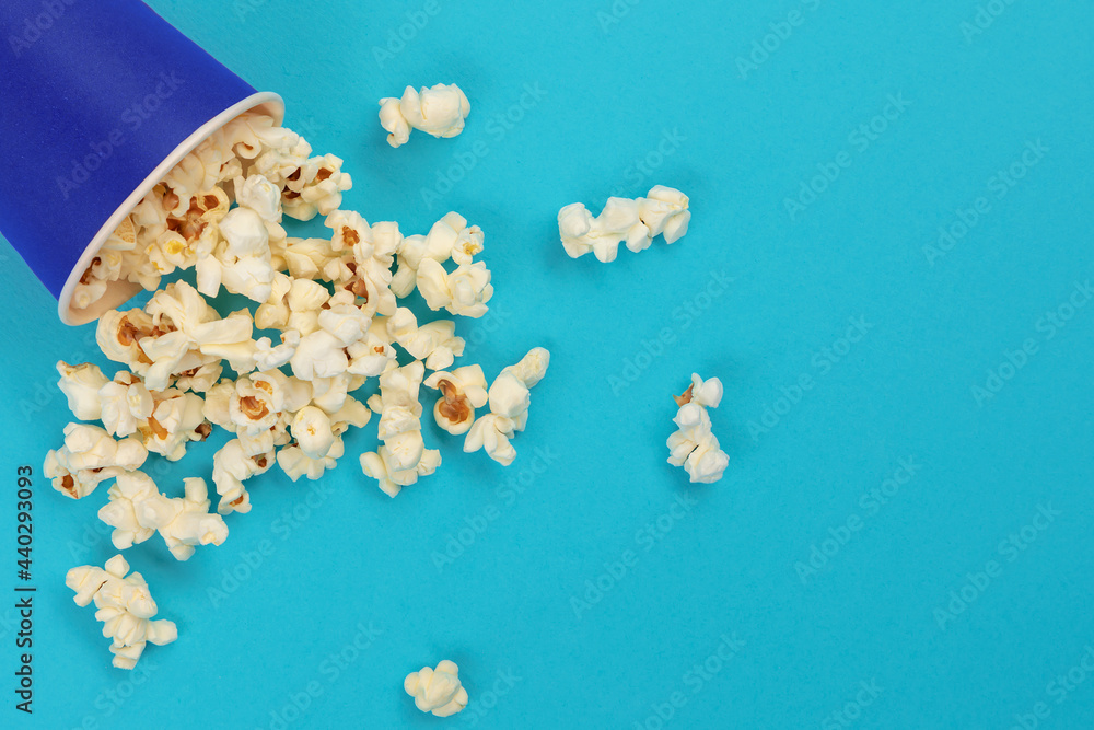 Popcorn shot from above on a blue background with space for text Popcorn shot from above on a blue background with space for text