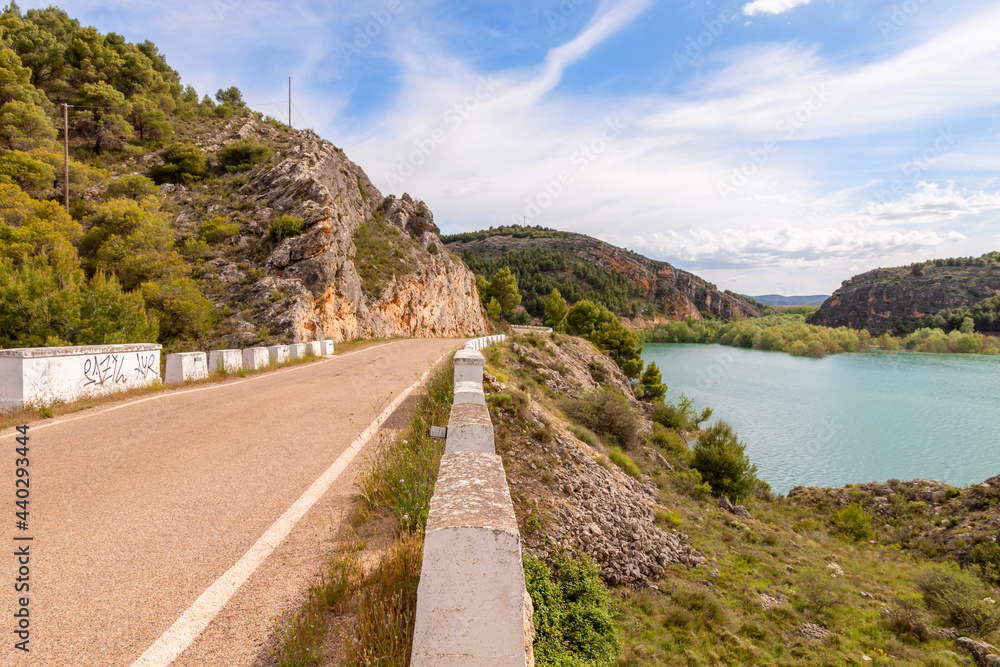 Beautiful road of Tranquera water reservoir in Nuévalos, Zaragoza, Aragón, Spain. Picture captured in a sunny summer day. Beautiful road of Tranquera water reservoir in Nuévalos, Zaragoza, Aragón, Spain. Picture captured in a sunny summer day.