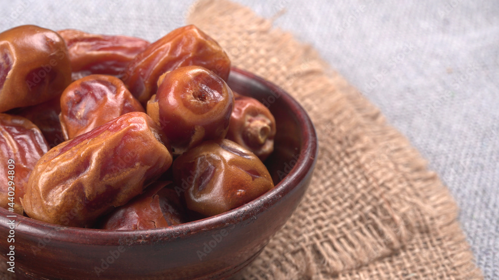 Dates in wooden bowl on background. dried dates fruit. Dates in wooden bowl on background. dried dates fruit.