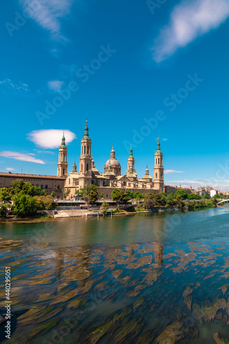 Picture of "Nuestra señora del Pilar" basilica in front of Ebro river captured during a sunny day. Zaragoza, Aragón, Spain.