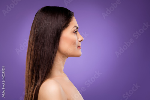 Photo of charming sweet mature woman naked shoulders looking empty space isolated violet color background