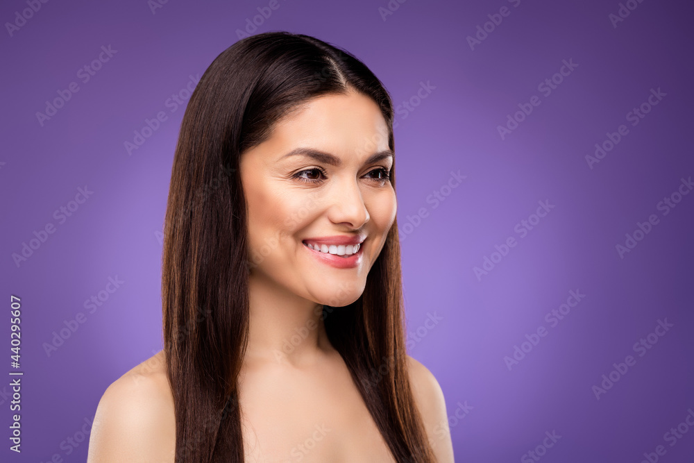 Photo of pretty charming mature woman naked shoulders smiling looking empty space isolated violet color background Photo of pretty charming mature woman naked shoulders smiling looking empty space isolated violet color background