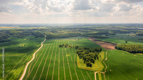 aerial view to countryside with green agricultural fields and forests