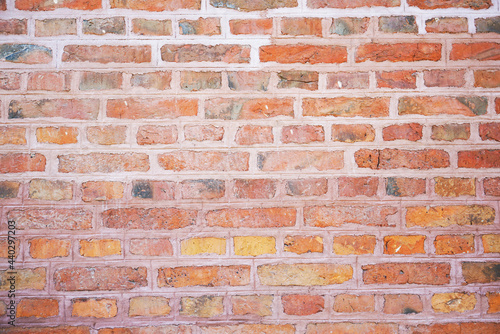Old wall made of red bricks. Background with the surface of a brick wall.
