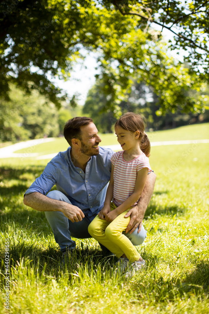 Fototapeta premium Father with daughter having fun on the grass at the park