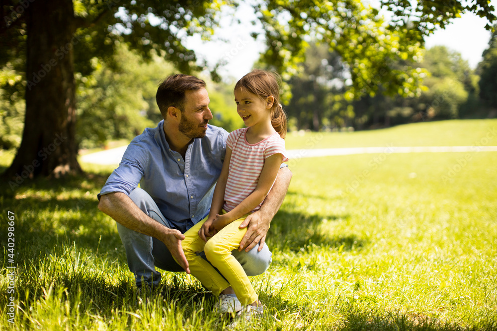Father with daughter having fun on the grass at the park Father with daughter having fun on the grass at the park