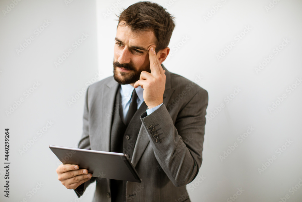 Young modern businessman using digital tablet in the office Young modern businessman using digital tablet in the office