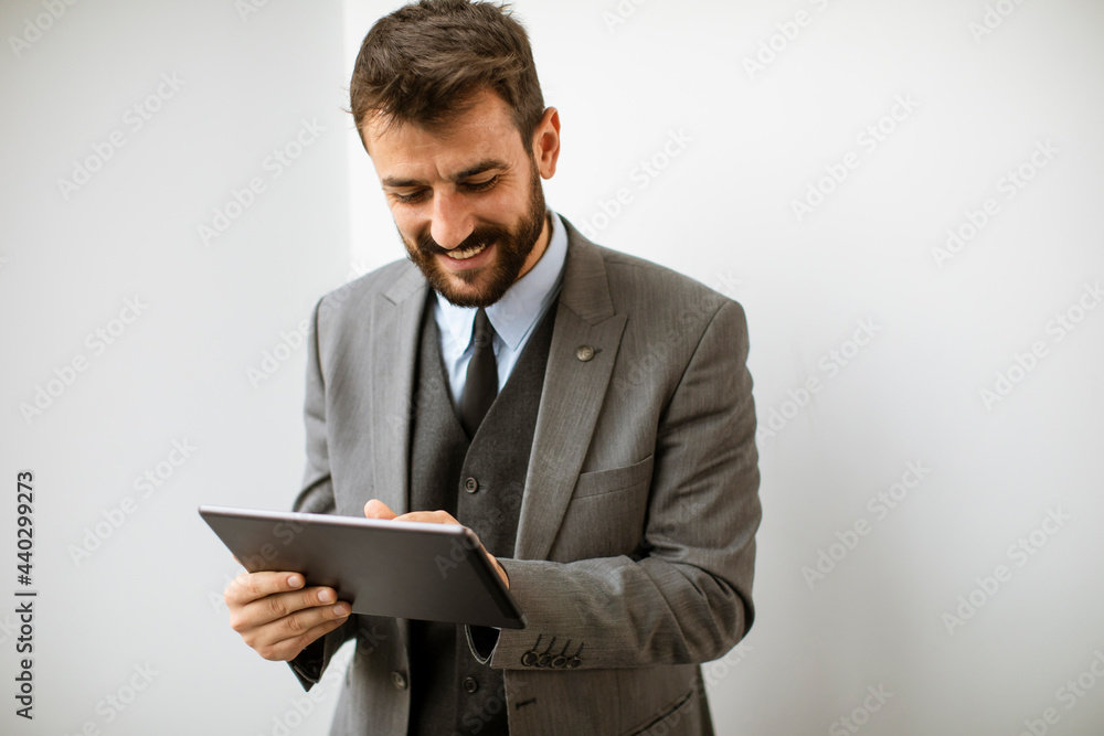 Young modern businessman using digital tablet in the office Young modern businessman using digital tablet in the office