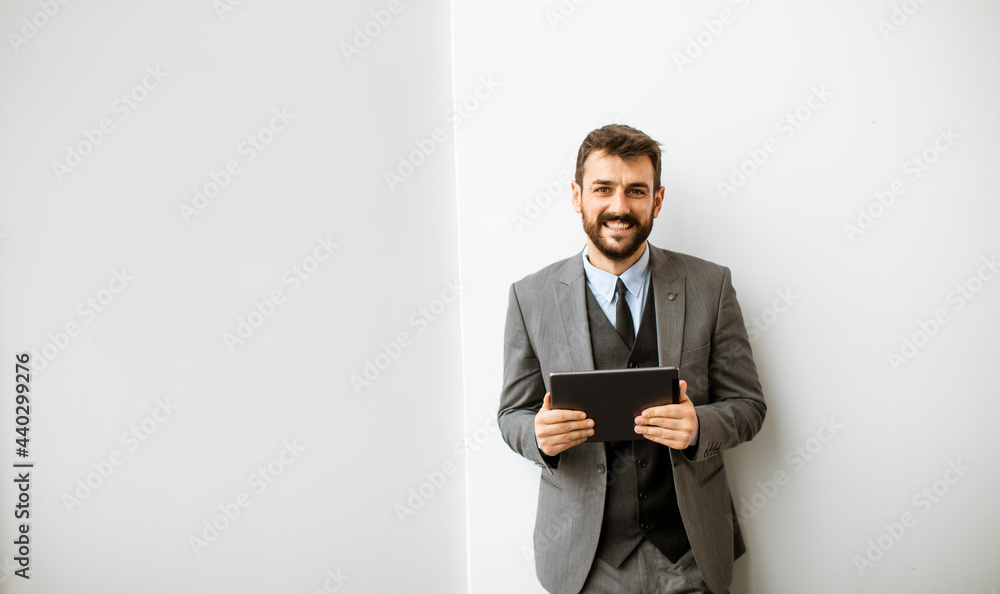 Young modern businessman using digital tablet in the office Young modern businessman using digital tablet in the office
