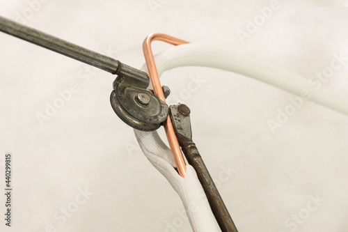 Tapeta Man hands bends copper pipes by pipe bender