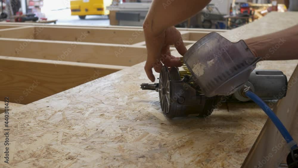 Reloading a nail gun to proceed with work Reloading a nail gun to proceed with work