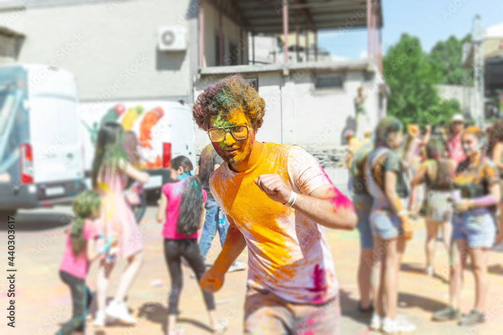 the pretty young boy in the color fest, colored faces of the peoples, color festival in india
