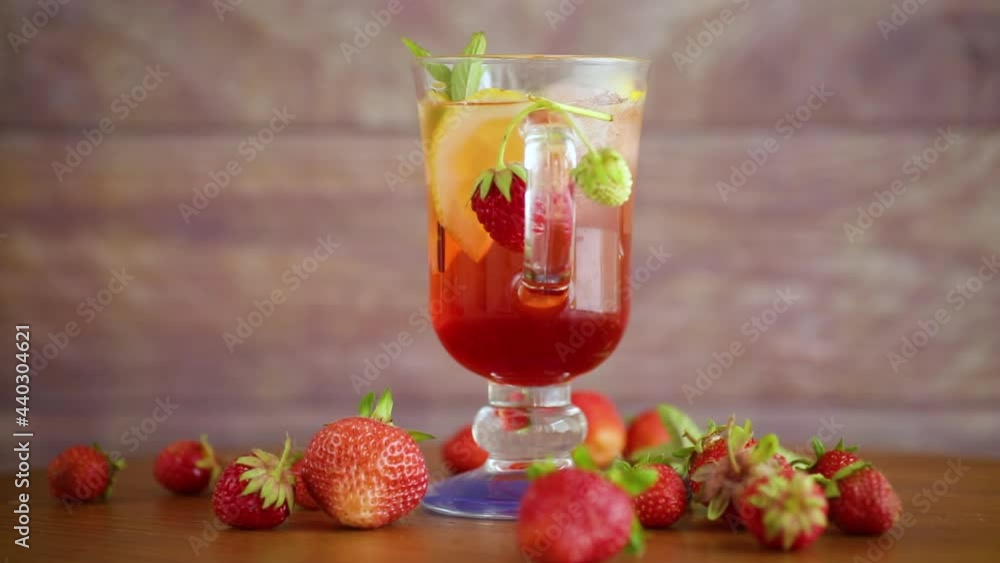 refreshing cool strawberry lemonade with lemon, ice and mint in a glass refreshing cool strawberry lemonade with lemon, ice and mint in a glass