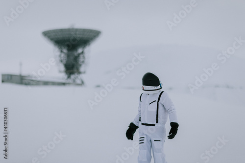 Spaceman in snowy field with dish satellites photo