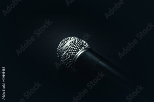 microphone on a black background. black texture with a microphone. music and sound concept photo