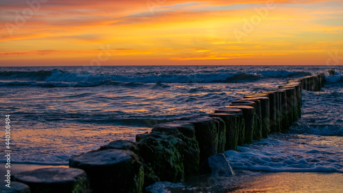 Scenic sunset with breakwater on Baltic Sea