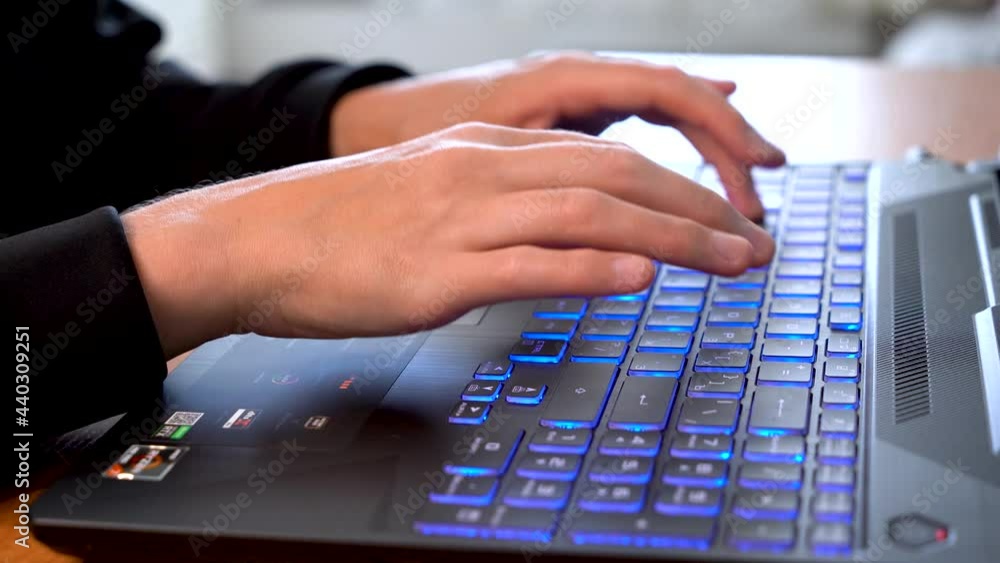 Women's beautiful hands typing on a laptop keyboard close-up. Blurred background. Women's beautiful hands typing on a laptop keyboard close-up. Blurred background.
