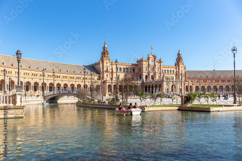 Beautiful and famous Spanish Square - "Plaza de Espana", touristic travel destination in Andalucía. People enjoying a warm day of winter. Recreation, Maria Luisa Park