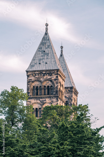 The high steeples of Lund cathedral sticking up over the tree tops in Lund Sweden