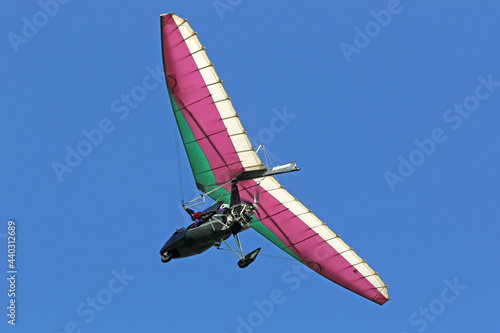 Canvas-taulu Ultralight airplane flying in a blue sky