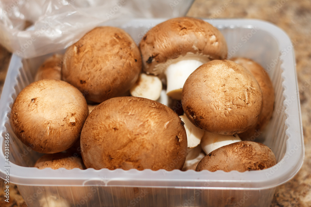 A box of fresh champignon mushrooms lies for a tasty dinner