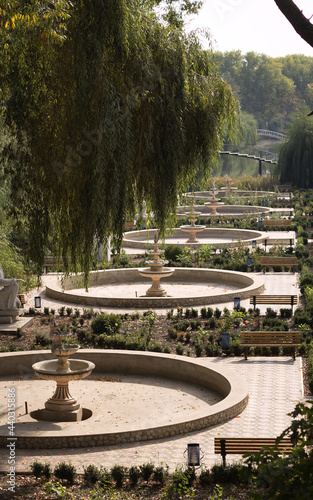 Landscape, resting place in the park, among fountains, shops and bridges