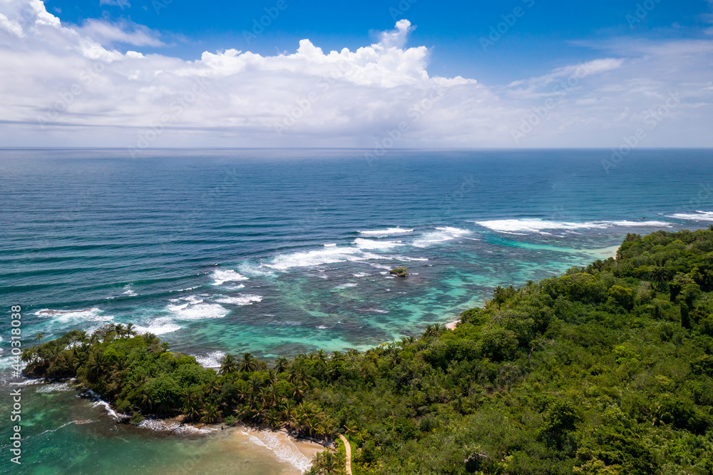 Tropical Island Aerial View. Wild coastline lush exotic green jungle. Red Frog Beach in Bastimentos Island, Bocas del Toro, Central America, Panama.