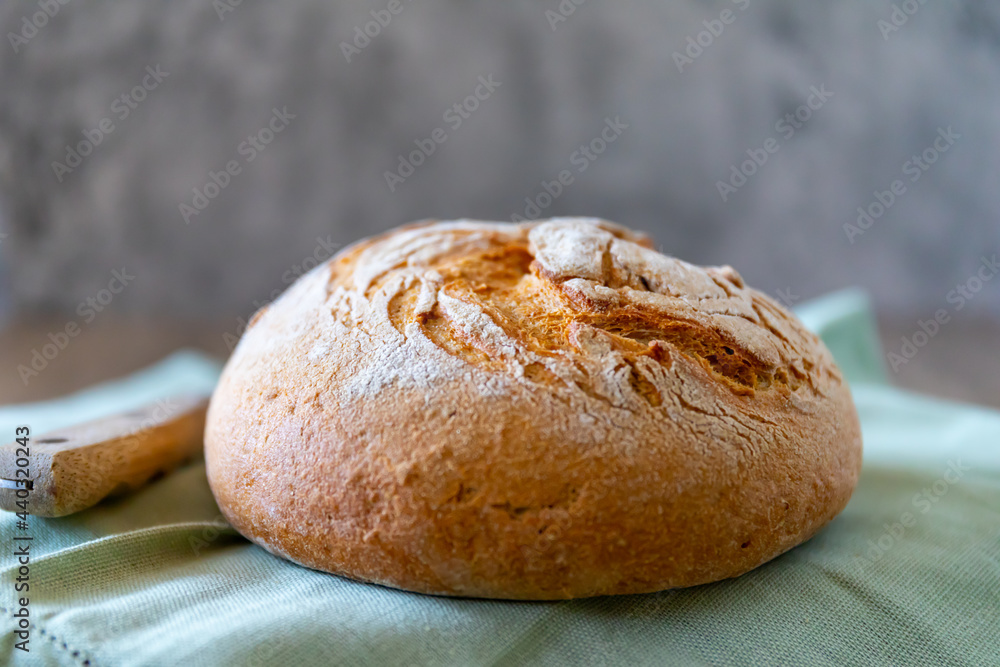 Rye bread lies on a light green textile and a gray background
