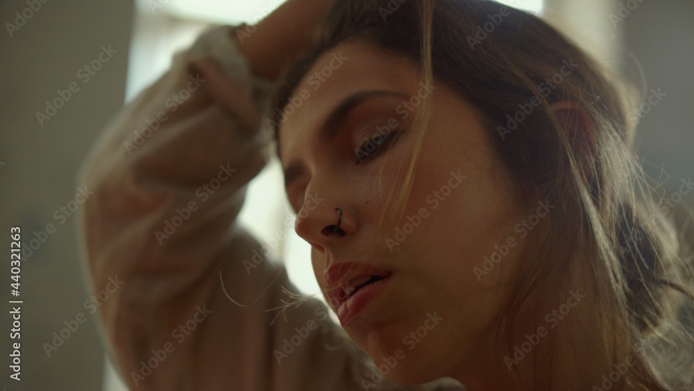 Fototapeta premium Creative woman creating masterpiece indoors. Tired painter wiping forehead.