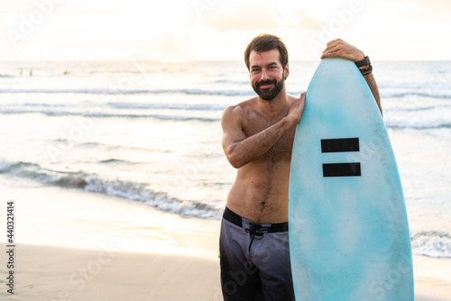 Young caucasian man get up early to doing surf at sunrise