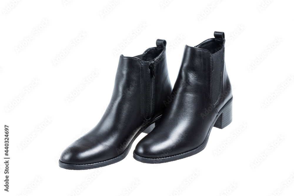 Pair of ladies black leather trendy boots, on white background