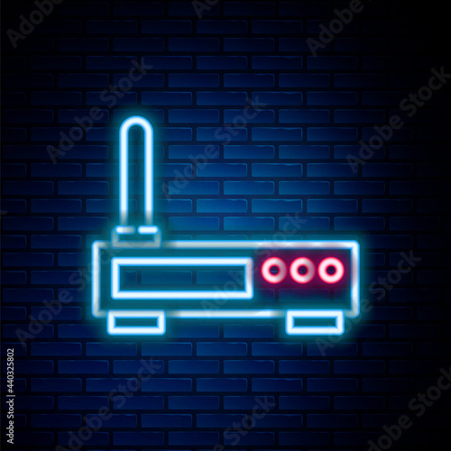 Glowing neon line Router and wi-fi signal icon isolated on brick wall background. Wireless ethernet modem router. Computer technology internet. Colorful outline concept. Vector
