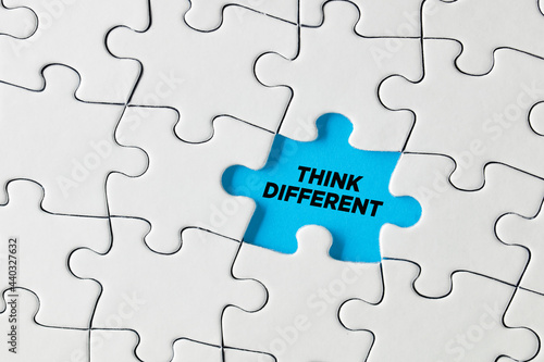 Think different written on blue missing puzzle piece. Creative thinking