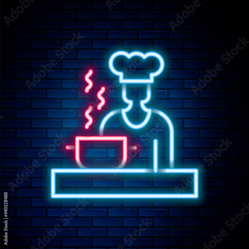 Glowing neon line Spanish cook icon isolated on brick wall background. Colorful outline concept. Vector