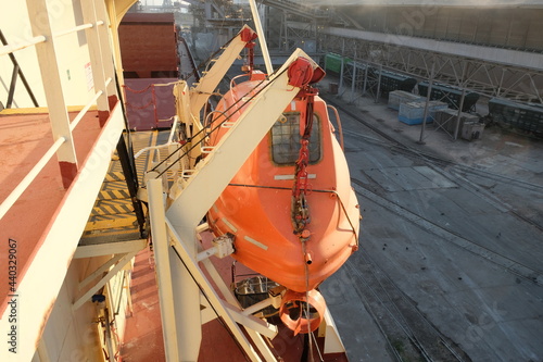 View of ship starboard side orange lifeboat with davit photo