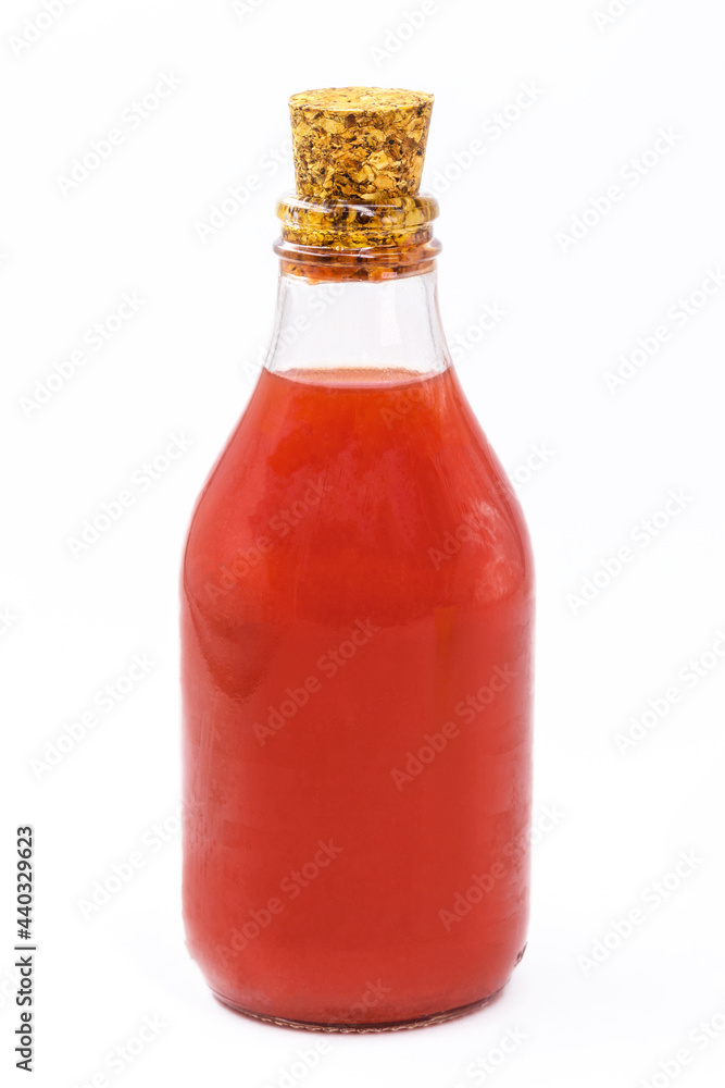 bottle of homemade tomato sauce, in glass with stopper, isolated white background. bottle of homemade tomato sauce, in glass with stopper, isolated white background.