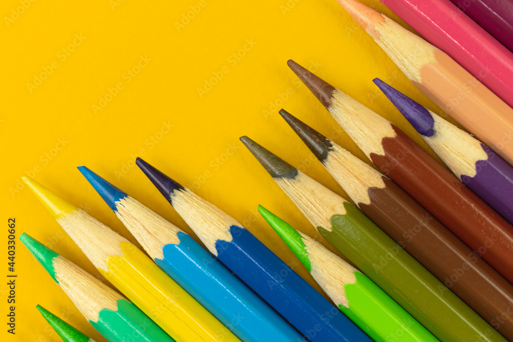Ready to drawing concept background, color pencils on a yellow table background Ready to drawing concept background, color pencils on a yellow table background