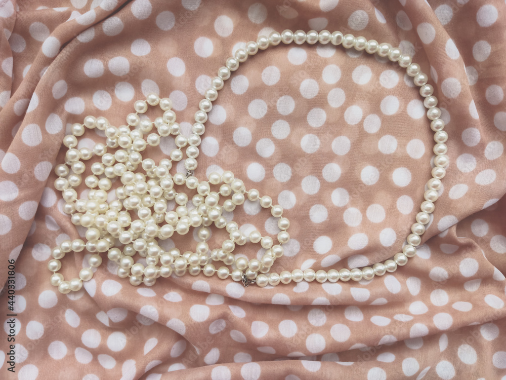 Beige background fabric textile dotted with white pearls 