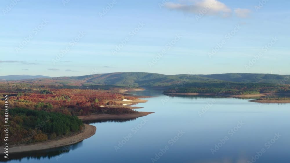 Drone aerial view of a lake reservoir of a dam with perfect reflection on the water of the sunset in Sabugal, Portugal Drone aerial view of a lake reservoir of a dam with perfect reflection on the water of the sunset in Sabugal, Portugal