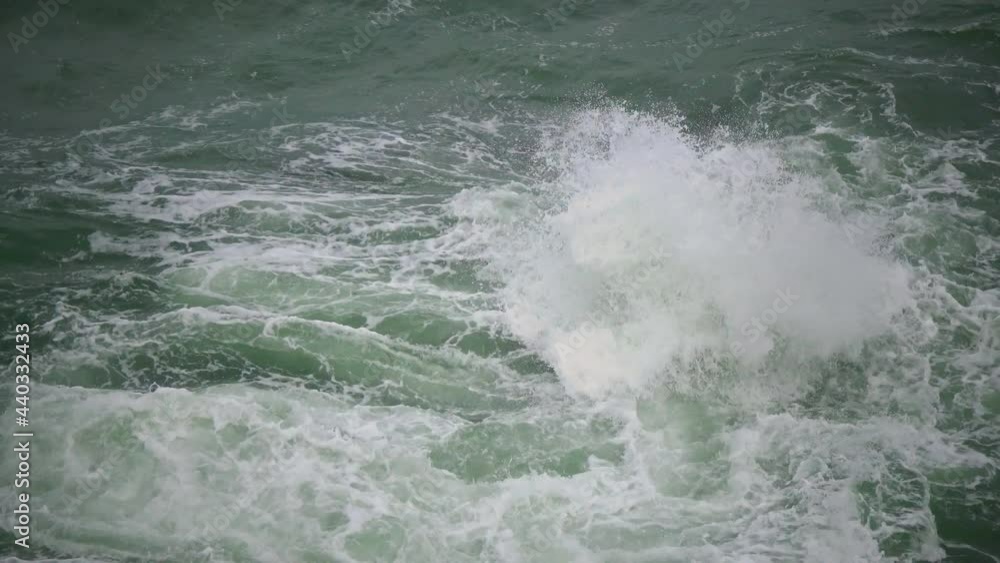 Strong storm near a rocky coast, white waves with foam in the sea, Black Sea, Bulgaria.