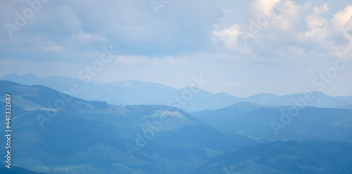 Mountain meadow on a sunny summer day against the backdrop of the Carpathian mountains in Ukraine